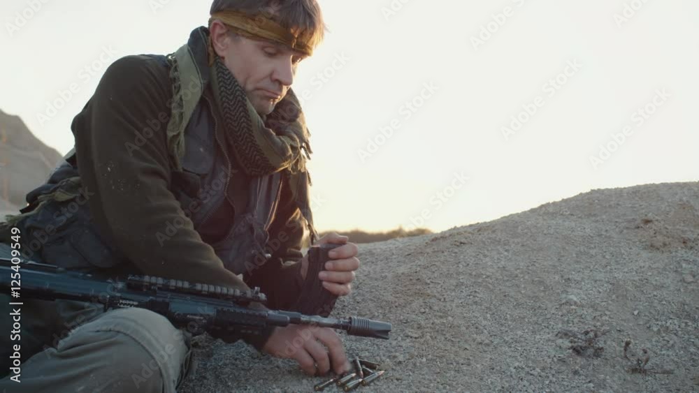 Terrorist reloading his Assault Rifle Magazine. Terrorist reloading his Assault Rifle Magazine.