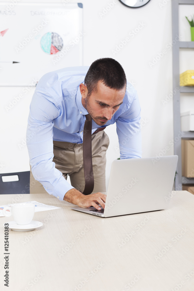 Young business man working on the laptop in his office