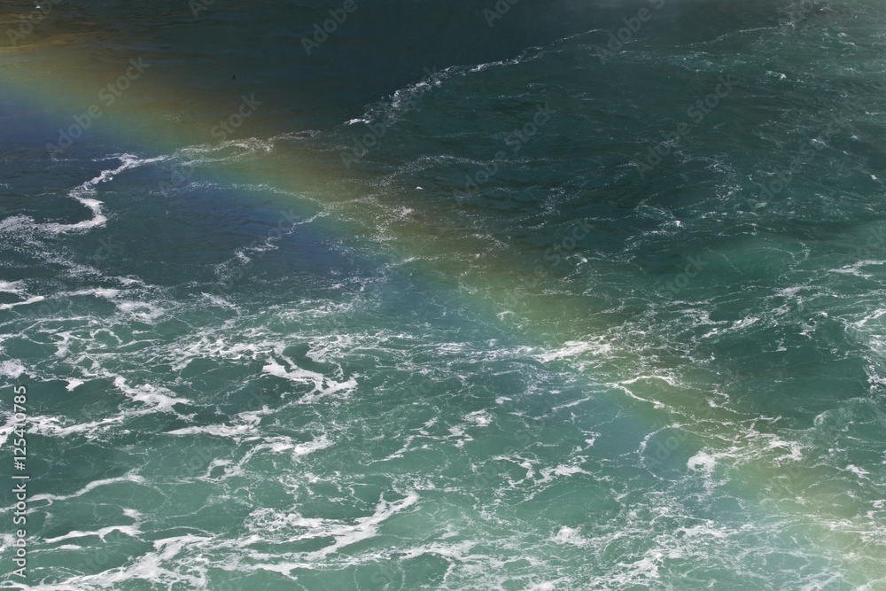 Beautiful background with the water near amazing Niagara falls with a rainbow Beautiful background with the water near amazing Niagara falls with a rainbow