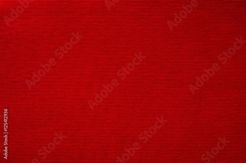 Red fabric background texture closeup.
