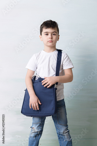 Obraz na plátně serious little boy with shoulder bag ilke grown-up