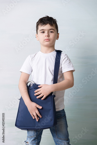 Photography serious little boy with shoulder bag ilke grown-up