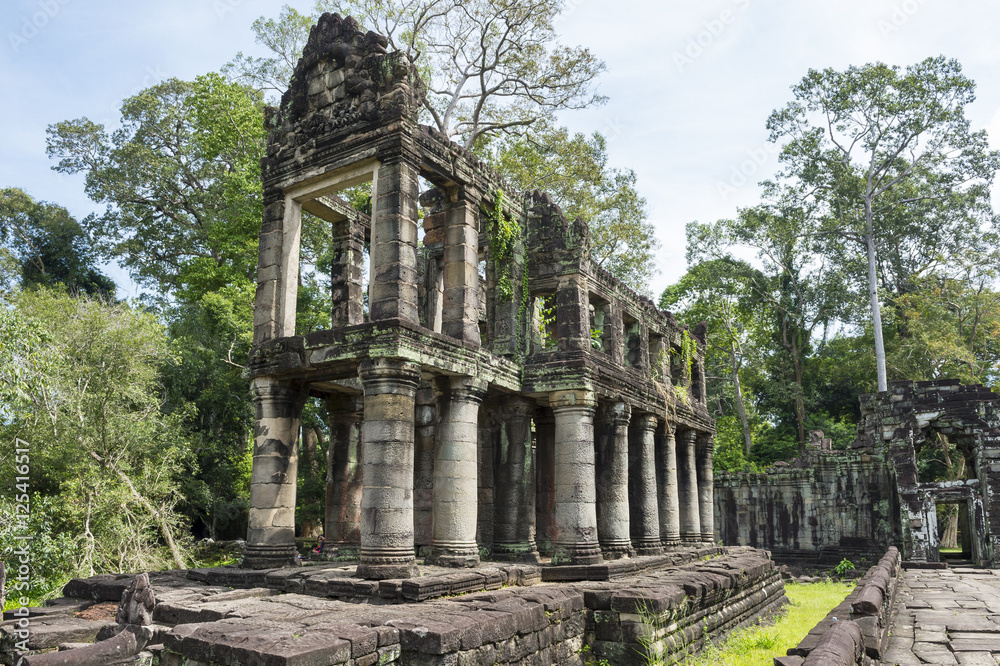 The ruins of Angkor Wat temple Preah Khan (a possible library and the only temple in the complex with circular columns), surrounded by jungle 