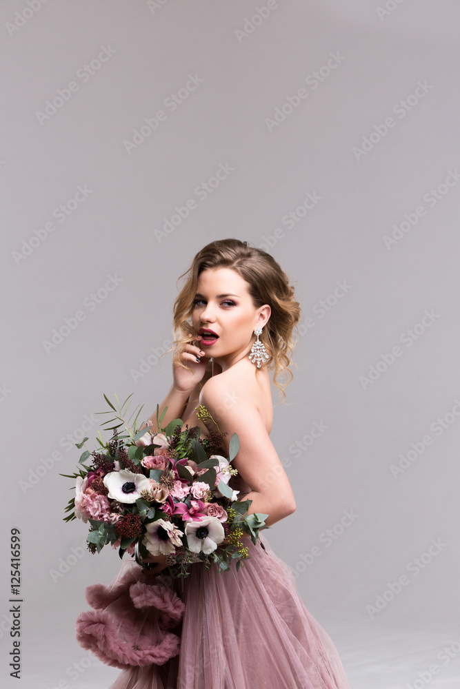 Hairstyle. Girl posing in pink dress full length. Studio Hairstyle. Girl posing in pink dress full length. Studio