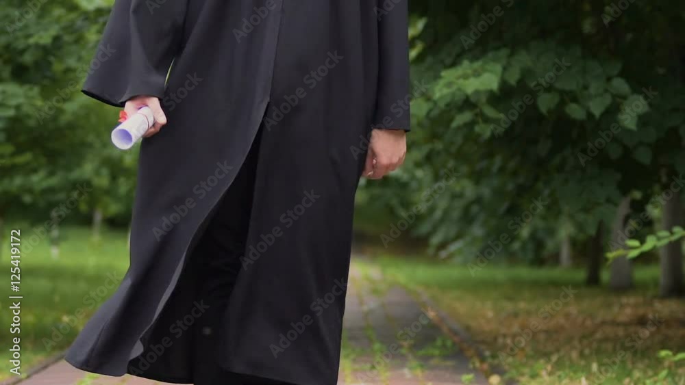 Happy satisfied male graduate jumping with joy after graduation, achievement Happy satisfied male graduate jumping with joy after graduation, achievement