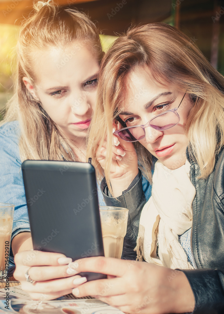 Two girlfriends having fun with digital tablet Two girlfriends having fun with digital tablet
