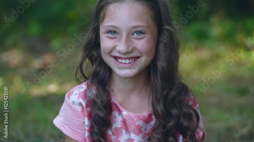 beautiful little girl smiling in the garden