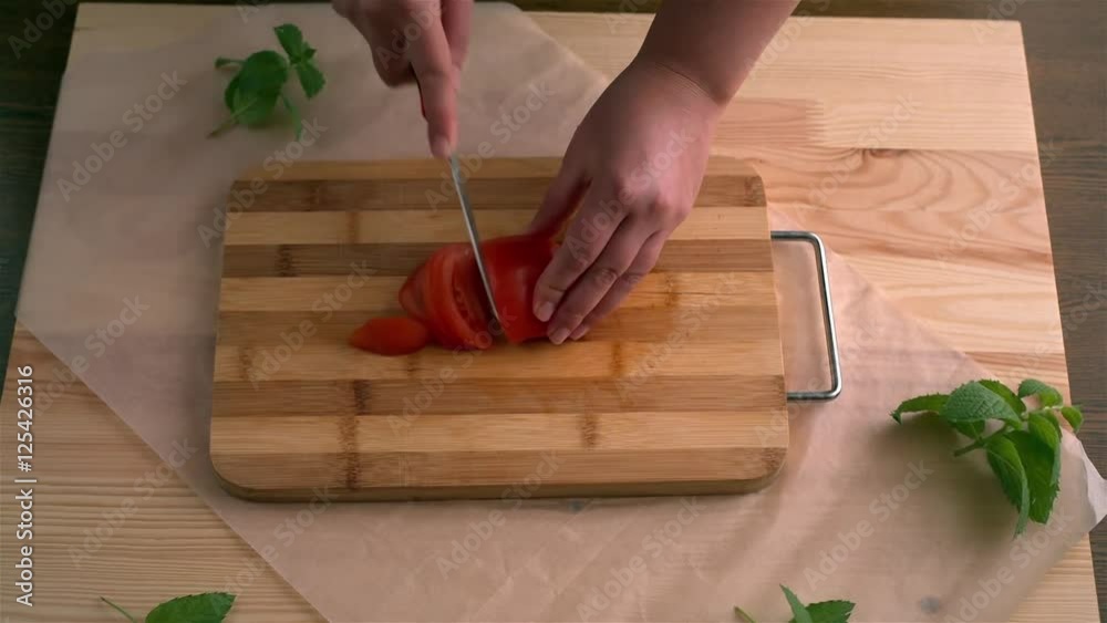 Cutting of tomato. Preparation of pizza on an unleavened wheat cake with chicken fillet. Cutting of tomato. Preparation of pizza on an unleavened wheat cake with chicken fillet.