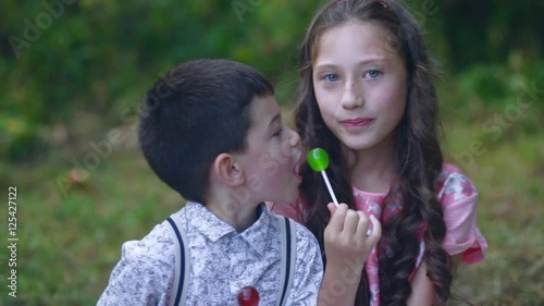 small children eat sweets in the garden