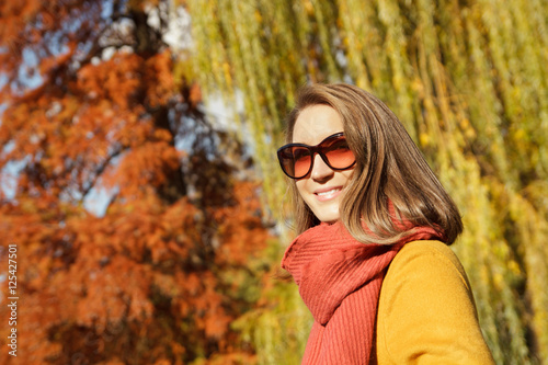 Beautiful young woman portrait in autumn park