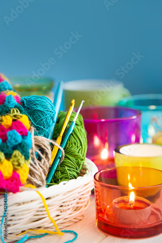 The white basket crochet fabric and colored yarn. Candles in candlesticks color.