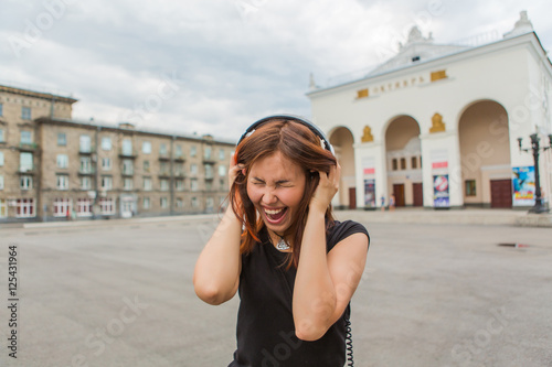 Asian girl listening to music with headphones
