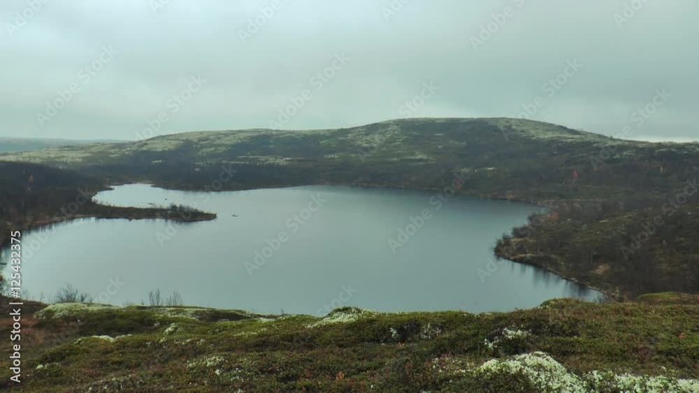 A small mountain lake in the tundra on a rainy autumn day.
A small mountain lake in the tundra on a rainy autumn day.