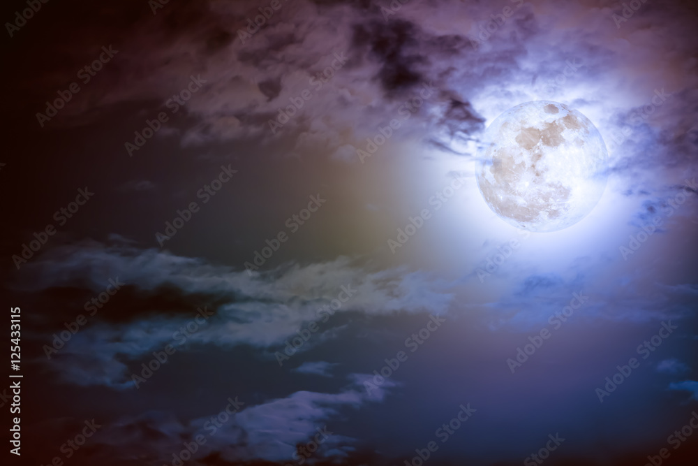 Nighttime sky with clouds and bright full moon with shiny.