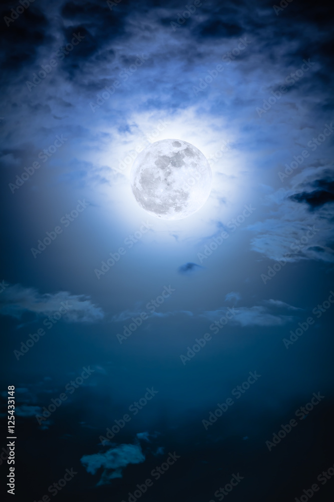 Nighttime sky with clouds and bright full moon with shiny.