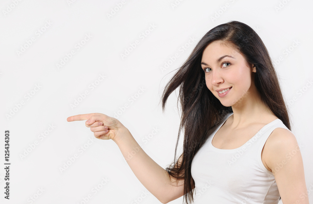 Portrait of young woman pointing at white background Portrait of young woman pointing at white background