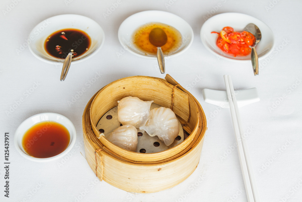 Dim sum food Steamed shrimp har gow dumpling in bamboo basket at