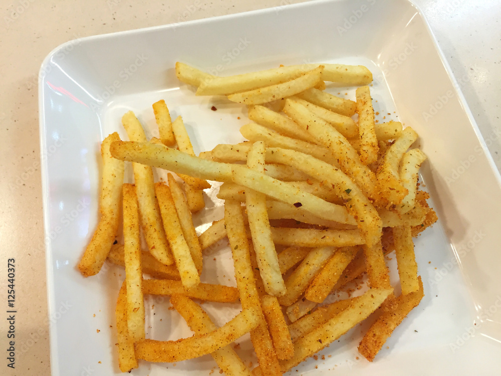 spicy french fries on white dish in restaurant, Thailand. spicy french fries on white dish in restaurant, Thailand.