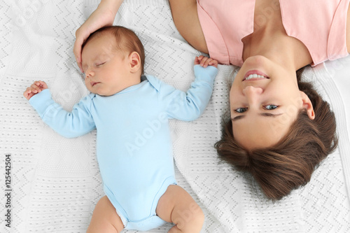 Young woman and her baby ly...