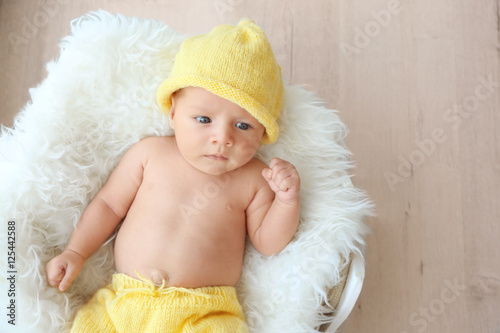 Cute baby lying on white fl...