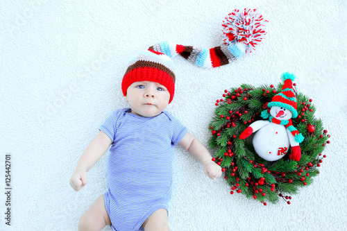 Cute baby lying on bedsprea...