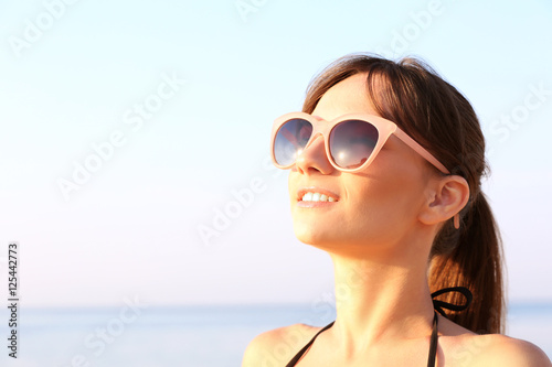 Young woman sunbathing on the sea background © Africa Studio