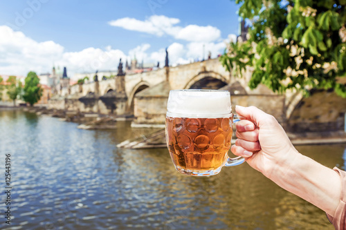 Canvas Print hand with a mug of the Czech beer against the background of Char
