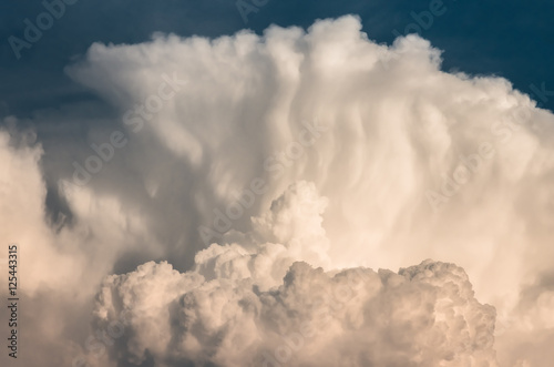 large cumulus storm clouds in the blue sky