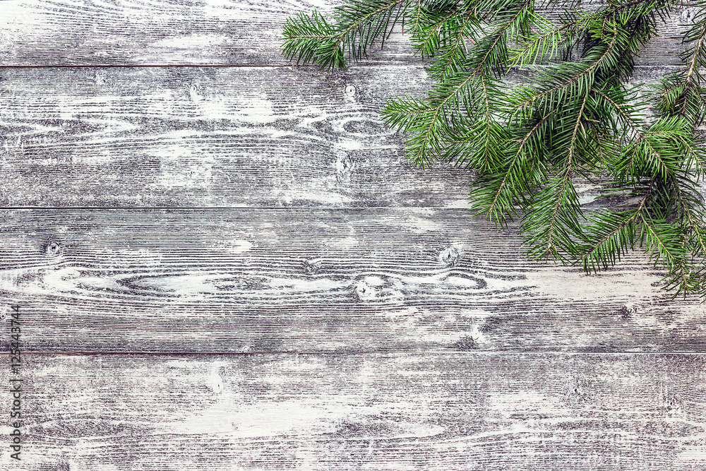 Christmas fir tree branches on gray wooden board. Space for text Christmas fir tree branches on gray wooden board. Space for text