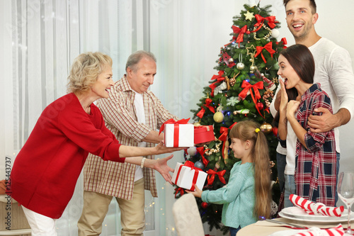 Happy members of family giv...