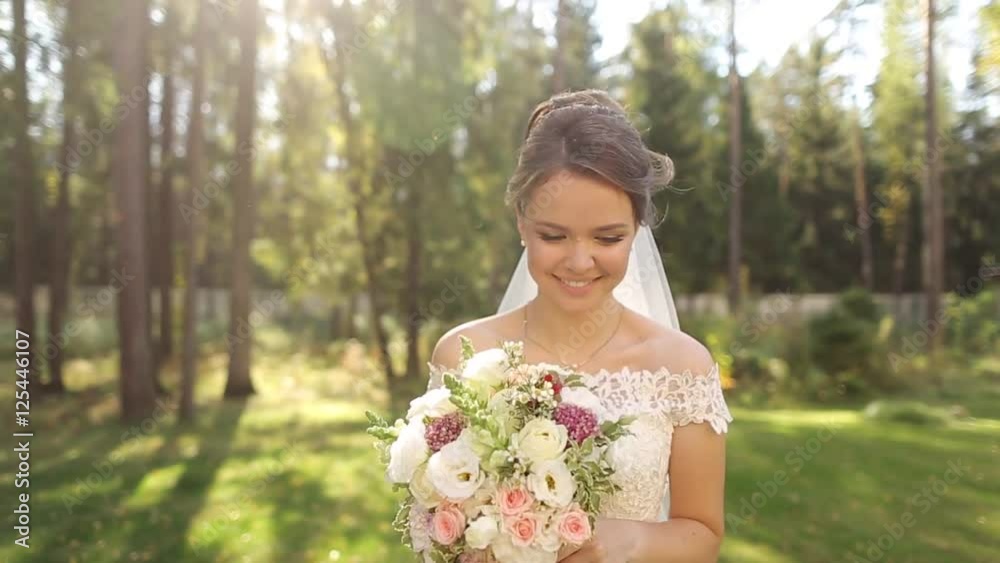 An incredibly beautiful bride in the spruce forest with a bouquet of flowers. An incredibly beautiful bride in the spruce forest with a bouquet of flowers.