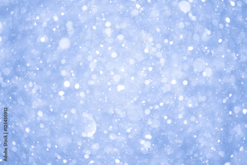 Abstract Blue Christmas Background with Real Snow. Blurred Snowflakes.