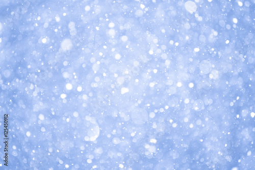 Abstract Blue Christmas Background with Real Snow. Blurred Snowflakes.