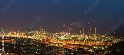 Night oil refinery  fuel manufacturer with city.