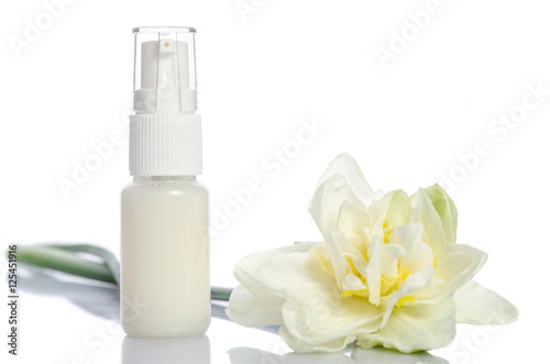 bottle with  lotion and flowers isolated on white