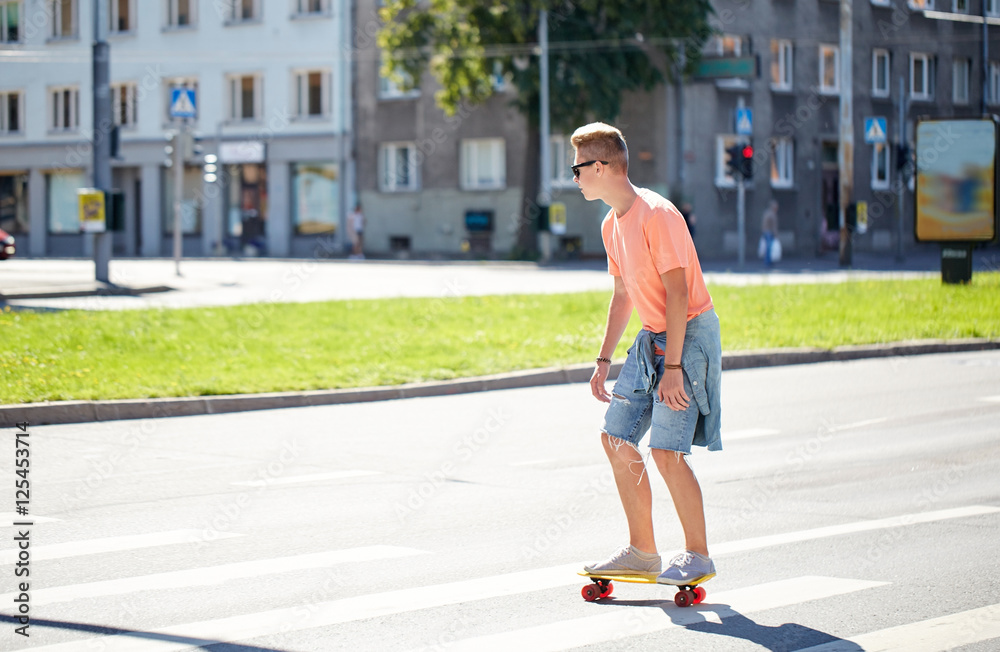 teenage boy on skateboard crossing city crosswalk teenage boy on skateboard crossing city crosswalk