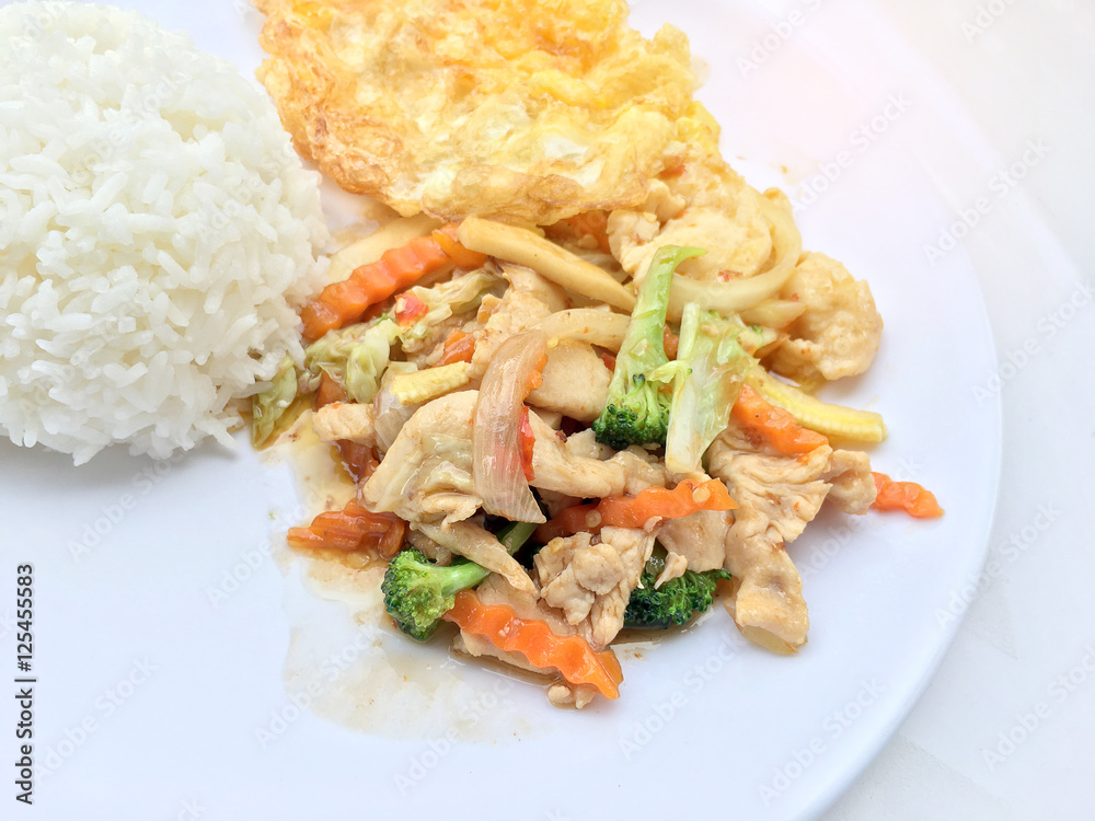 stir fry vegetables with chicken fillet, fried egg with rice in white dish on white background. stir fry vegetables with chicken fillet, fried egg with rice in white dish on white background.