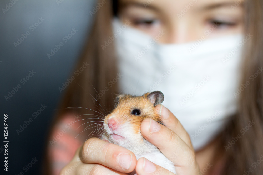 Girl with medical mask and hamster allergy concept Girl with medical mask and hamster allergy concept