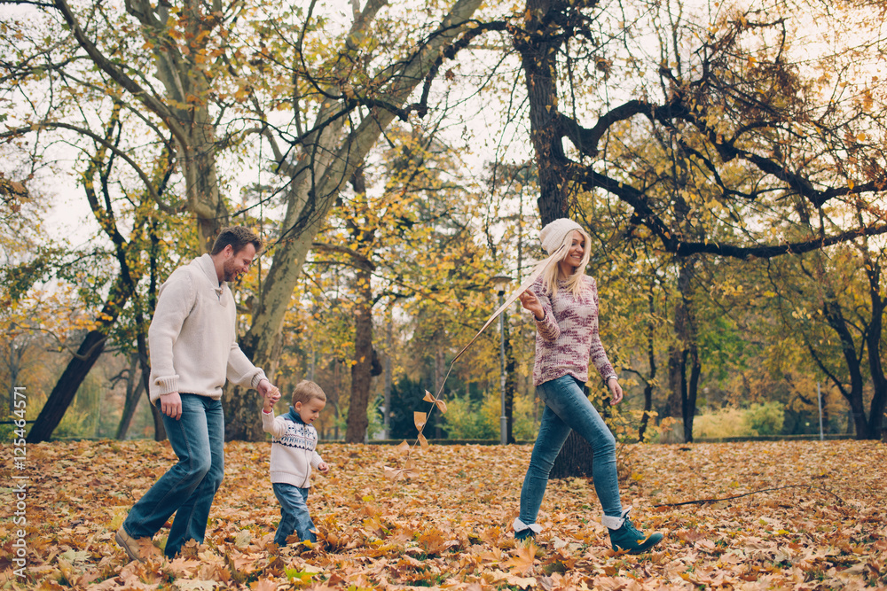 Dad, mom and son flying a kite in nature Dad, mom and son flying a kite in nature
