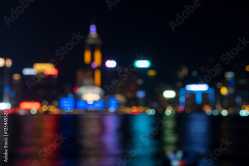 Abstract bokeh city light background of Hong Kong Victoria harbor at night, taken from Tsim Sha Tsui seaside, Kowloon
