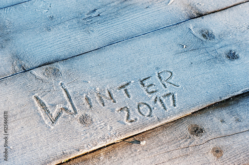 Winter 2017 written on a wooden background with frosts