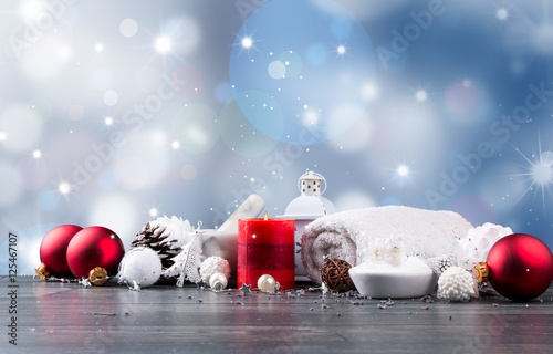 spa massage setting, lavender product, oil and christmas decoration on wooden background, Christmas wellness concept