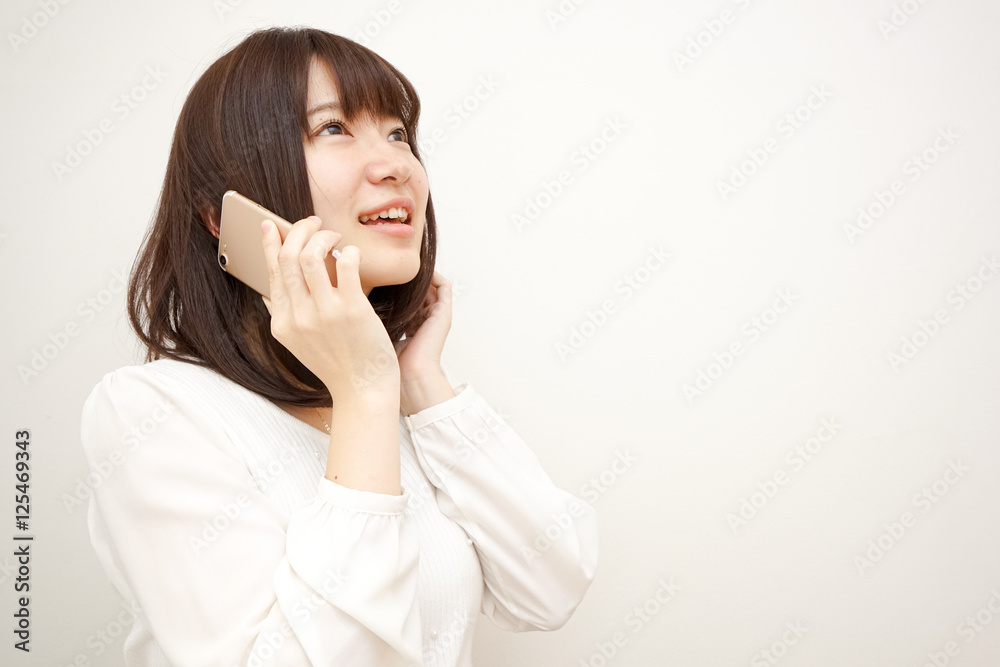Young woman talking on the phone with smile Young woman talking on the phone with smile