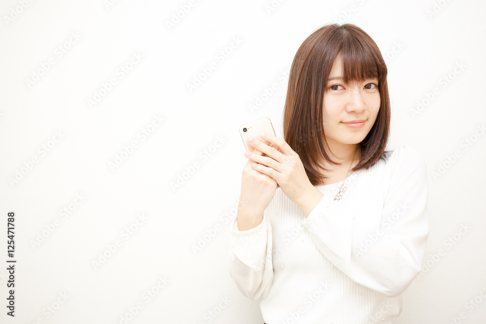 Young woman using a smart phone with smile Young woman using a smart phone with smile