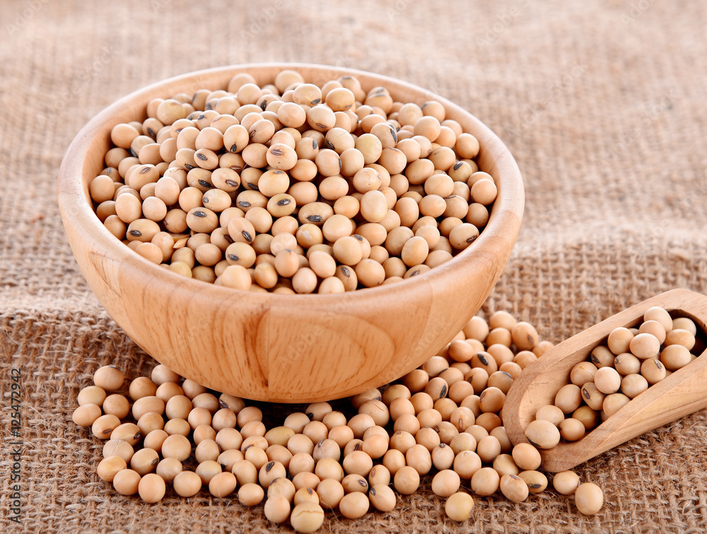 Soybeans in wood cup sackcloth background Soybeans in wood cup sackcloth background