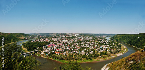 Panorama view of small city round peninsula with river and bridg