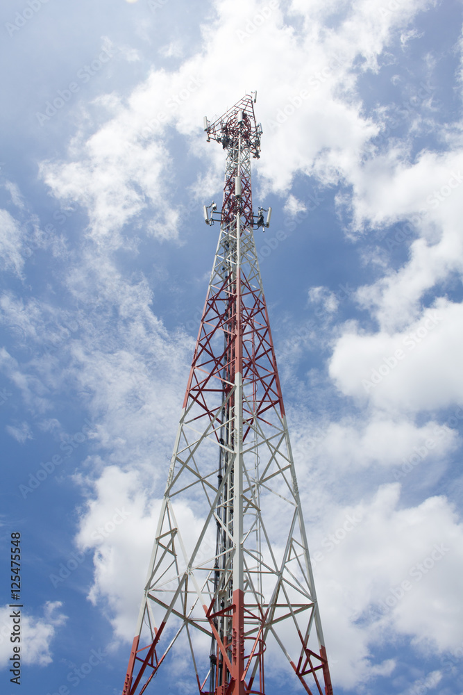 Mobile phone towers over white cloud and blue sky in rural areas Mobile phone towers over white cloud and blue sky in rural areas