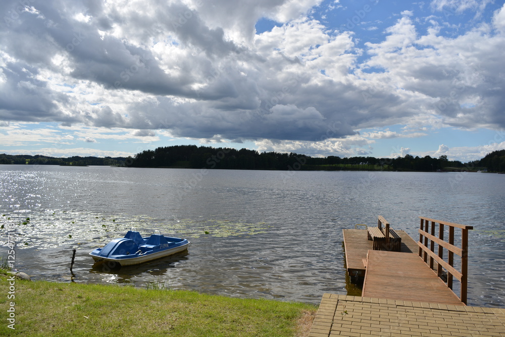 lake landscape with boat ant wooden bridge