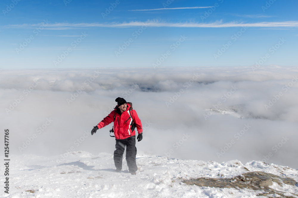 Male hiker in Carpathian mountains on top of snowy peak