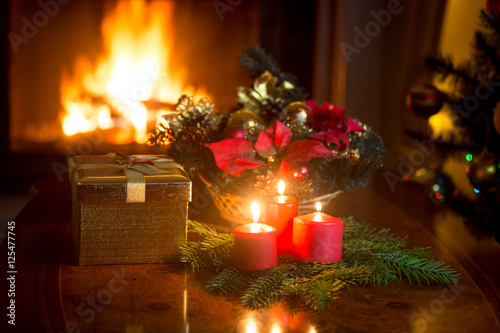 Beautiful background  with burning candles and ireplace at Chris photo